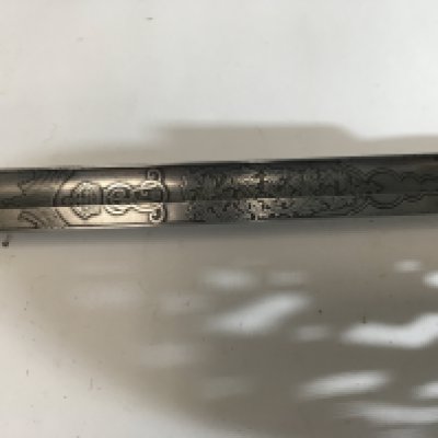 An interesting Edward VII Military sword with engraved blade and edge Military numbered 16164 possible made in Germany for the British Army.