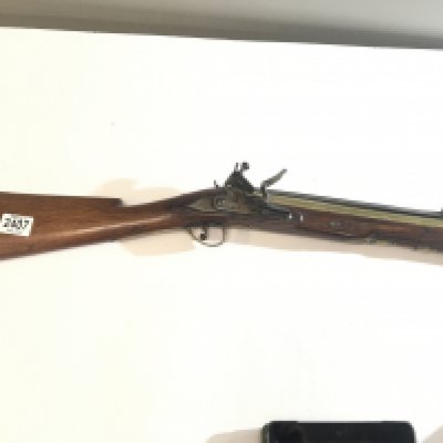 A late 18th century British Blunderbuss with brass canon barrel full length walnut stock brass fittings steel action and with a long flick sprung bayonet the barrel with proof house marks nice condition functional action.