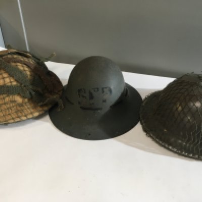 Four Military helmets an SFP home front British II world war helmet two other British helmets and a World War II Czechoslovak helmet (4)