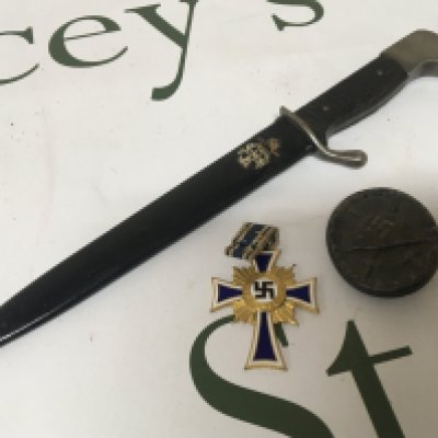 A German Third Reich paper knife, a German II world war wound badge and an enamel and gold Civil Cross of Honour given to Mothers of the third Reich. (3)