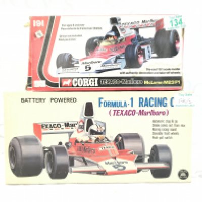 A Vintage Alps Japanese Battery Powered Formula 1 Smoking Race Car. And A Corgi Texaco-Marlboro McLaren M23F1 #191.