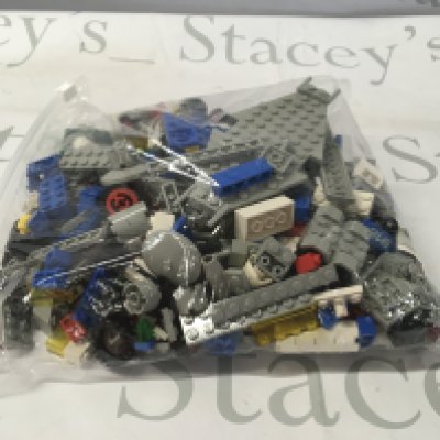 A bag containing an assortment of loose Lego building pieces. No reserve