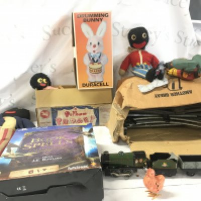 An assorted collection including 3 Gollies one being a Pelham puppet..a boxed Duracell drumming bunny..a Triang clockwork train with track 0 gauge..a perished vintage Mickey Mouse and a PS3 Book of Spells. No reserve