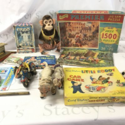 An assorted collection of older toys featuring numerous characters including Snow White..Noddy etc. includes jigsaws..clockwork toys etc. no reserve