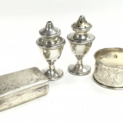 A Collection on silver items including a snuff box, napkin ring and shakers. Postage category A