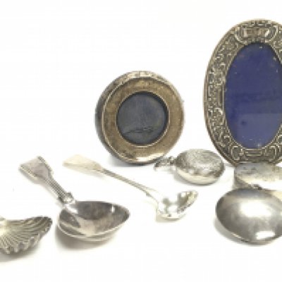 A Collection of hallmarked silver items including spoons, containers and photo frames. this lot cannot be posted