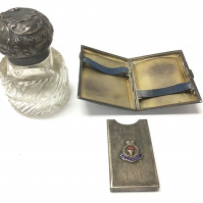 A silver topped inkwell and a cigarette case. Postage B