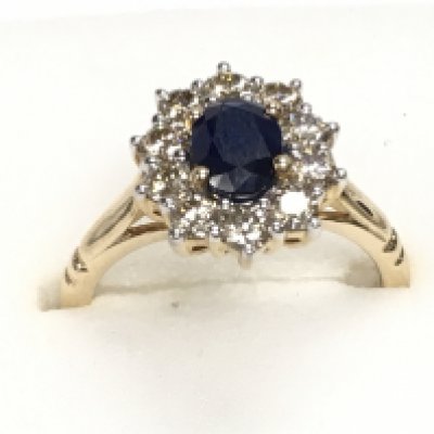 9ct yellow gold ring set with oval sapphire and a halo of RBC diamonds, boxed. Sapphire 1.00ct Approx. Diamonds 0.81ct. Ring size Approx N. Postage category A.