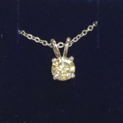 Certificated 18ct white gold solitaire pendant set with fancy yellow RBC diamond on a silver chain, boxed. Diamond 0.51ct. Cert no. WGI9624147028. Postage category A.