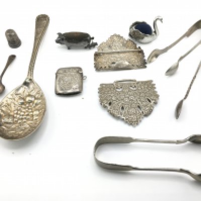 A collection of silver items and other oddments. Including silver pin cushion and spoons. Postage B