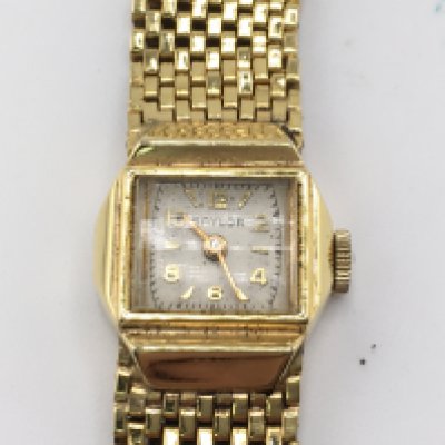 A 14ct gold watch with 14ct strap. 26.90g Postage A