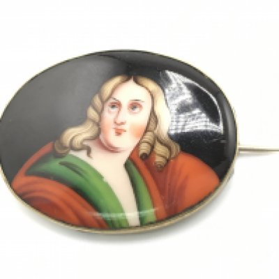 A vintage porcelain brooch. Approximately 5cm wide. Postage B