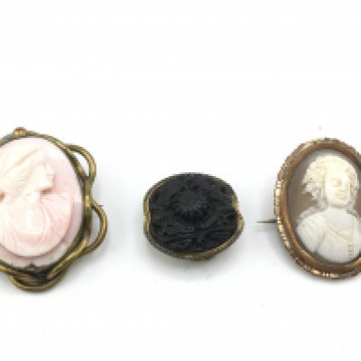 Three cameo style brooches. Postage B