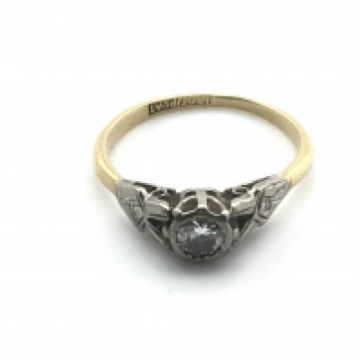 An 18ct gold and platinum ring set with a small diamond. 2.3g and size N 1/2