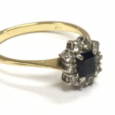 An 18 carat gold diamond and black sapphire ring, 3.3g size Q, postage category A