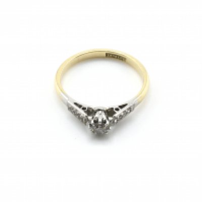 An 18ct gold and platinum ring set with a small diamond. Size L 1/2 and 2.10g