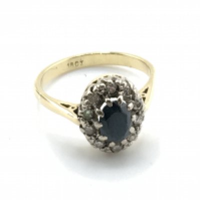 An 18 carat gold sapphire and diamond cluster ring, size K/L. 3.8g. Postage category a