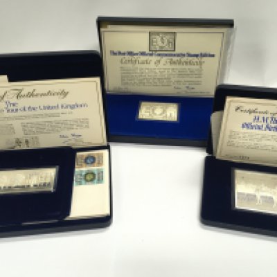 A collection of three silver ingots approximately 2oz each with COAs. Postage B