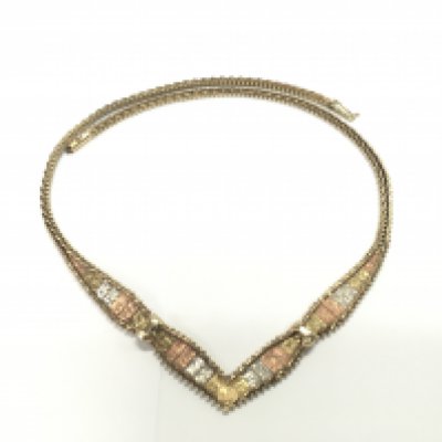 A 9ct gold three colour necklace. 20.48g Postage A