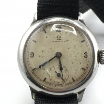 A vintage Omega watch on canvas strap. Approximately 1930's with 31mm case. Wind and runs. Postage B