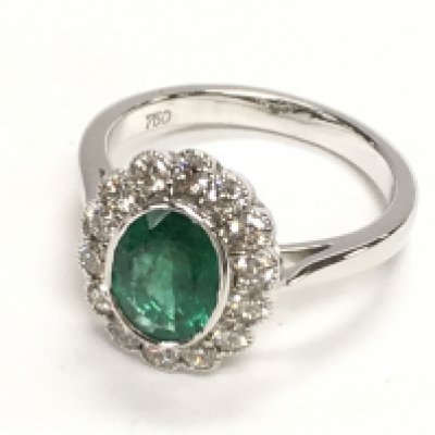 18ct white gold ring with an oval emerald and a halo of RBC diamonds in a beaded setting. Emerald 1.08ct. Diamonds 0.57ct. Ring size Approx M. Postage category A.