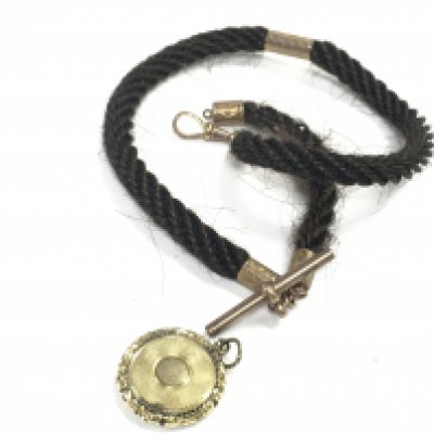 A plated hair Albert chain and locket. Postage category A