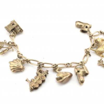 A 9ct gold charm bracelet with multiple charms. 40.66gPostage A