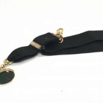 A yellow metal fob seal and watch clip