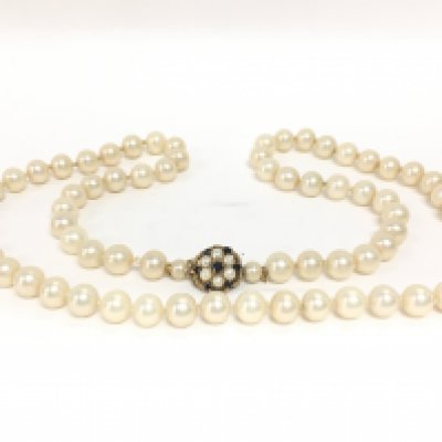 A string of simulated pearls with a 9 carat gold clasp set with blue sapphires and cultured pearls. NO RESERVE