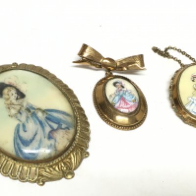 Three vintage Perspex and gilt TLM Lady brooches. This lot cannot be posted
