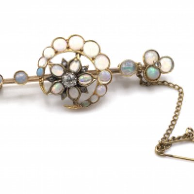 An Edwardian opal and diamond crescent moon and flower brooch. High carat gold.Postage A