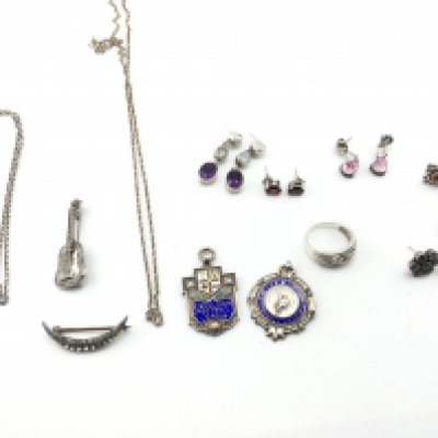 A collection of silver jewellery including chains earrings and medals. Postage B