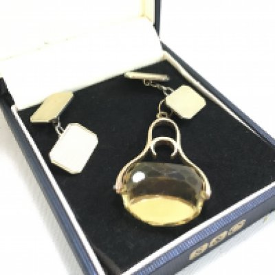 A yellow metal and citrine fob and a pair of silver cufflinks. Postage category A