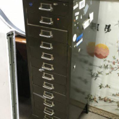 A twelve drawer filing cabinet of watch parts including some Omega. Also including some tools