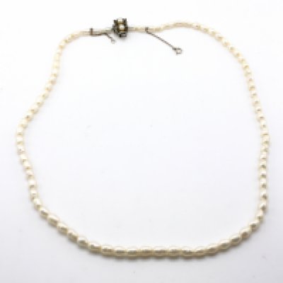 A pearl necklace with a silver clasp.