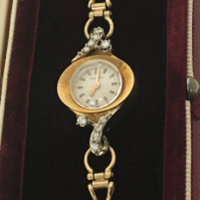 A Vintage Omega ladies watch the shaped 18carat gold case set with brilliant cut diamonds the reverse with winding crown. With an attached 9carat gold open link bracelet strap. In a fitted box total weight 15g