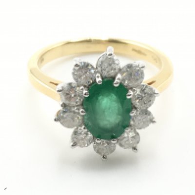 WITHDRAWN - A quality 18carat gold ring set with an emerald flanked by a pattern of brilliant cut diamonds.the emerald approximately 10x7mm each diamond approximately 0.12. Total weight 5g ring size N-O