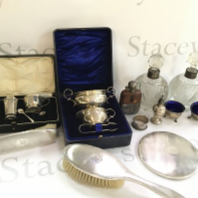 A Collection of silver hallmarked items including a grooming set, silver and leather flask, silver collared decanters, cased condiment set etc. This lot cannot be posted