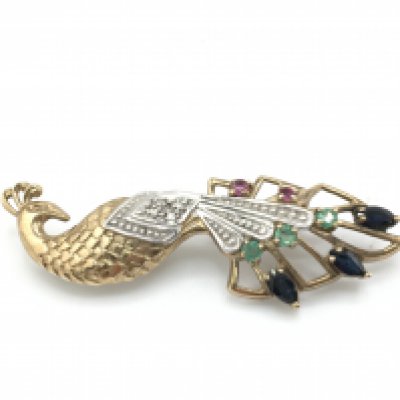 A 9ct gold peacock brooch set with gems including ruby and sapphires. 5g Postage B