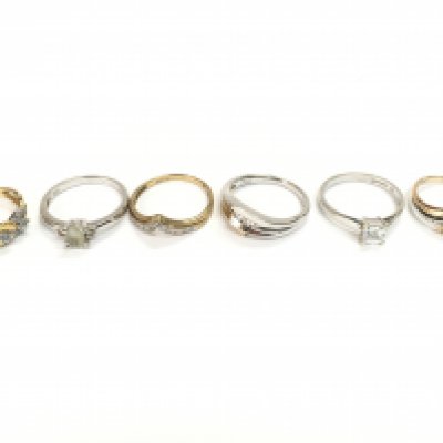 Three 9ct white gold and three 9ct gold rings all set with assorted stones. 12.70g Postage A