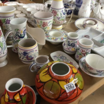 A collection of Poole pottery including lamp vases jugs vases and dishes .