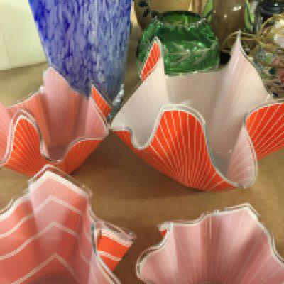 A collection of glass ware including four handkerchief vases and two vases .