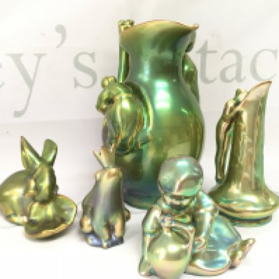 A collection of Zsolnay Pecs lustre glazed pottery Figures and a jug. This lot cannot be posted