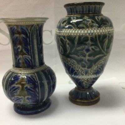 Two Doulton Lambeth vases decorated with foliage including ELisa Simmannce 16 cm and 18 cm .