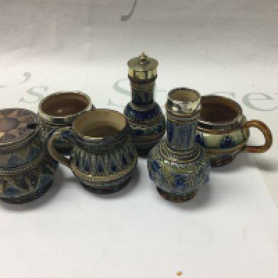 A collection of six Doulton Lambeth cruets with silver plated mounts And floral decoration .