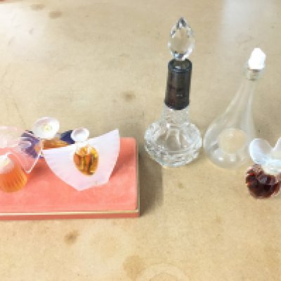 A Rene Lalique St Odile fruit liqueur bottle miniature early 1920s together with Lalique miniatures perfume bottles and early 20th century cut glass silver collared scent bottle.