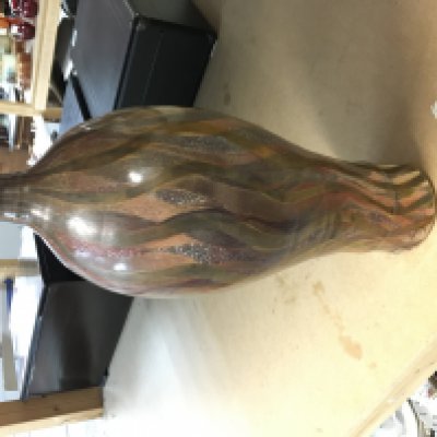 Sutton Taylor Cinnabar earthware bottle covered in lustred polychrome flame like decoration. Impressed ST and LH for Lotherton hall 1980s 42.5cm tall. Good condition.