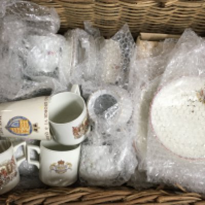 A basket containing Royal Commemorative ceramics including plates, cups etc