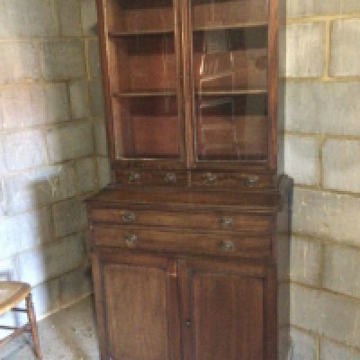 An Early 19th century late Regency Mahogany cabinet with glazed doors above small drawers and cupboards. 180cm heigh 80cm wide approximately.
