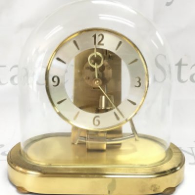 A mid 20th century Kunda West German clock under a glass dome, for restoration